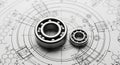 Two Ball Bearings Resting on Engineering Blueprints with Technical Drawings and Measurements Royalty Free Stock Photo