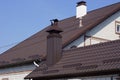 Two metal chimneys on a brown tiled roof Royalty Free Stock Photo