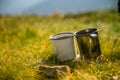 Two metal cups with tea on the mountain. Outdoors breakfast during the hike.
