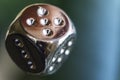 Two metal dices on glass background