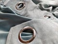 Two metal eyelets on gray-blue velvet curtains Royalty Free Stock Photo