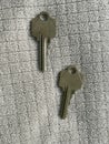Two metal keys resting on cloth