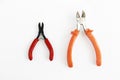 Two metal old rusty pliers with red and orange handle Royalty Free Stock Photo