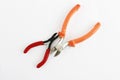 Two metal old rusty pliers with red and orange handle Royalty Free Stock Photo