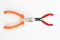 Two metal old rusty pliers with red and orange handle Royalty Free Stock Photo
