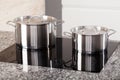 Two metal pots on induction hob Royalty Free Stock Photo