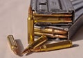 Two metal rifle magazines, one stacked upon the other, loaded with .223 caliber bullets with four additional bullets Royalty Free Stock Photo