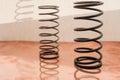 Two Metal Springs on the Copper Surface. Royalty Free Stock Photo