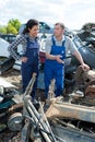 two metal workers in scrap metal yard Royalty Free Stock Photo