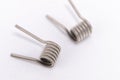 Two Metallic Coils on White Background, Close-up of Spring-like Structures, Silver Metal Royalty Free Stock Photo