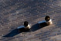 Two ventilation pipes installed on a brick wall in an urban setting Royalty Free Stock Photo
