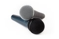 Two microphones laying on top of each other, pair of singing mics together, objects isolated on white background, cut out, singing Royalty Free Stock Photo