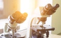 Two microscopes stand in the laboratory, close-up, sunlight