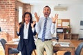 Two middle age business workers standing working together in a meeting at the office celebrating crazy and amazed for success with Royalty Free Stock Photo