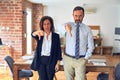 Two middle age business workers standing working together in a meeting at the office looking unhappy and angry showing rejection Royalty Free Stock Photo