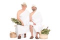 Two middle-aged men in traditional Russian sauna