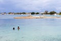 Two middle aged Micronesian women in closing enjoying swimming in rocky blue turquoise lagoon, Majuro city. Marshall islands.