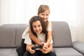 Two middle school girls at home playing an exciting video game together. Royalty Free Stock Photo