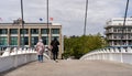 Two migrant women crossing the Footbridge across Commerce Basin in Le Havre