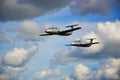 Two military aircraft flying in white clouds