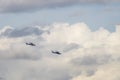 Two military helicopters flying against a beautiful sky with clouds Royalty Free Stock Photo