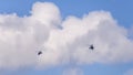 Two military helicopters flying against a beautiful sky with clouds Royalty Free Stock Photo