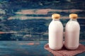 Two milk bottle on wood table