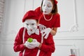 Two mime artists in red costumes, scene with apple Royalty Free Stock Photo