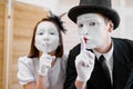 Two mime artists, secret gesture, parody