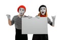 Two mimes holding a big blank board and leaning on invisible wall