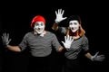 Two mimes touching invisible wall. Smiling faces of artists Royalty Free Stock Photo