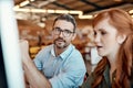 Two minds are even more productive than one. a young businesswoman and mature businessman using a computer together in a Royalty Free Stock Photo