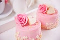 Two mini cakes with roses on a white table. Romantic dinner concept