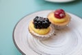 Mini fruit italian cupcakes with fresh berries on board Royalty Free Stock Photo