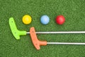 Two Mini Golf Putters and Three Balls Royalty Free Stock Photo