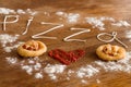 Two mini pizzas with sausage and cheese on wood table Royalty Free Stock Photo