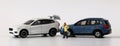 Two miniature cars collided with Miniature man calling.