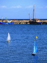 Two miniature sailboats cruising in harbor basin in northern Germany