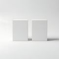 Two minimalist white rectangular boxes placed side by side on a neutral surface Royalty Free Stock Photo
