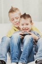 Two mischievous young boys playing video games together Royalty Free Stock Photo