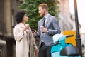 Two mixed race business people talking outside company Royalty Free Stock Photo