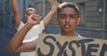 Two mixed race men on a protest march holding placards raising hands and shouting