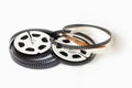 Two 8mm film reels with film strips scattered around. Studio shot. Royalty Free Stock Photo