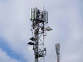 Two mobile phone tower antennas on the top of the hill