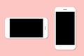 Two mobile phones with blank screens for text isolated over pink background. Modern cell phones needed for communication. Digital Royalty Free Stock Photo