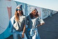 Models wearing plain tshirt and sunglasses posing over street wa Royalty Free Stock Photo