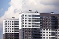 Modern apartment buildings painted in white and brown colors against sky