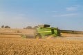 Two modern combine harvester cutting crops corn wheat barley working golden field Royalty Free Stock Photo