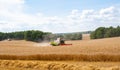 Combines at work in field during wheat harvesting