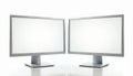 Two modern computer monitors with blank white screens side by side on a clean white desk. Sleek silver frames and stands. Perfect Royalty Free Stock Photo